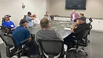 Small breakout group discussing business strategies at Stone Industry Education event