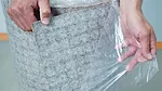 Schluter Peel-and-Stick uncoupling membrane being demonstrated how to use.