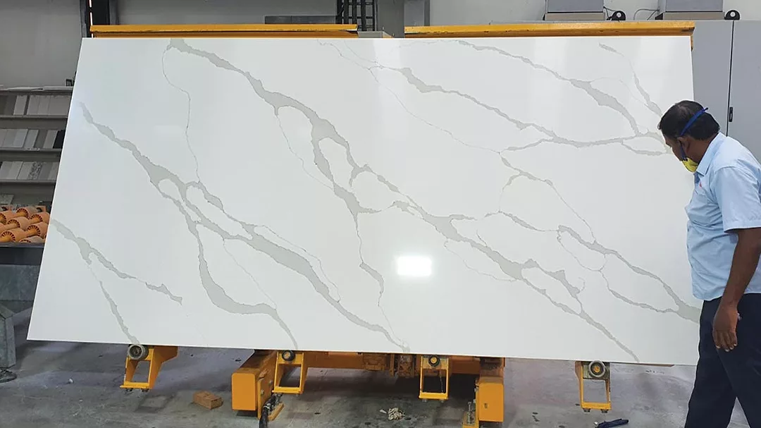 Workers with a quartz slab at TabQuartz facility