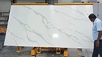 Workers with a quartz slab at TabQuartz facility