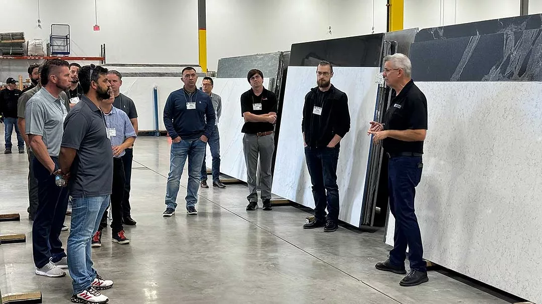 Participants of Stone Summit receiving a tour of slab facility at Marble of the World.