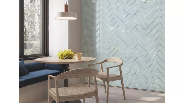 light blue herringbone pattern tile on wall