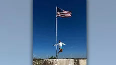 Marcette Gordon jumping off stone block during 2024 NSI Study Tour