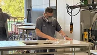 Polishing a countertop wearing a respirator