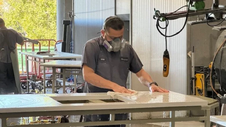 Polishing a countertop wearing a respirator