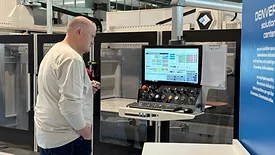 Fabricator looking at screen of CNC machine