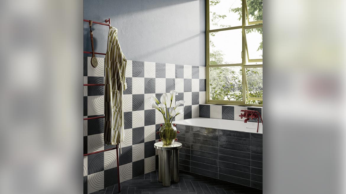a bathroom with walls partially covered in a black and white checkered tile pattern
