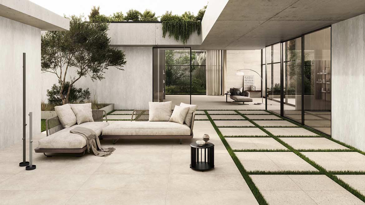 The image shows an outdoor space featuring the CiViC collection of porcelain stoneware tiles from Ceramiche Caesar. 