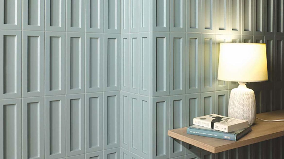 The image appears to show a wall with textured tiles. The tiles are likely from a collection by Natucer