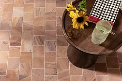 meta-quartzite tile collection from Arto used on the floor, sunflower on table