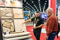 Attendee viewing stone samples at Hardscape North America 2025