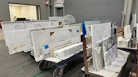 countertops on racks at a fabrication shop