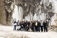 Group of architects and designers standing in Italian marble quarry