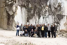 Group of architects and designers standing in Italian marble quarry