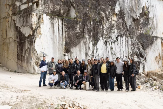 Group of architects and designers standing in Italian marble quarry
