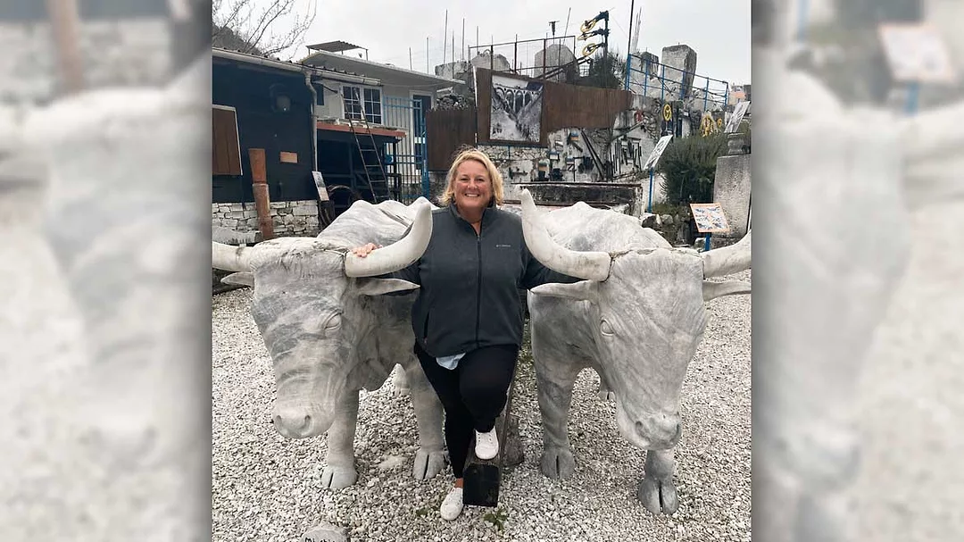 Glenda Henneboehle with stone bull statues