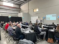 Blake Christensen speaking to a group of fabricators