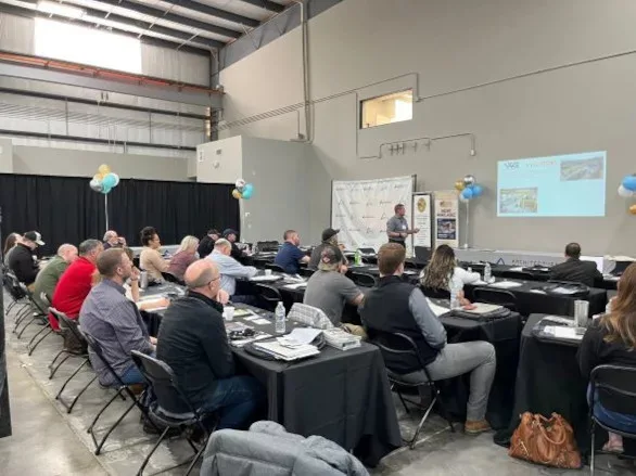 Blake Christensen speaking to a group of fabricators