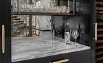 lighted bar in the dining area with White Shadow marble counter top