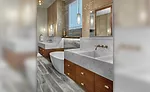 wooden cabinetry and Opal Calcite sinks in master bathroom