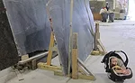 soapstone slabs supported by an unstable wooden frame and nylon straps