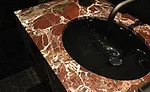 Rosso Rubino marble vanity tops and Nero Marquina marble wall tiles