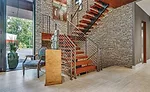 massive floor-to-ceiling stone accent wall up the stairway