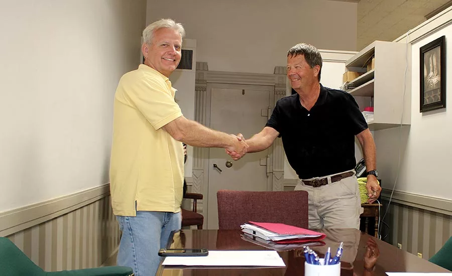 Scott Buechel shakes hands