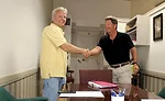 Scott Buechel shakes hands