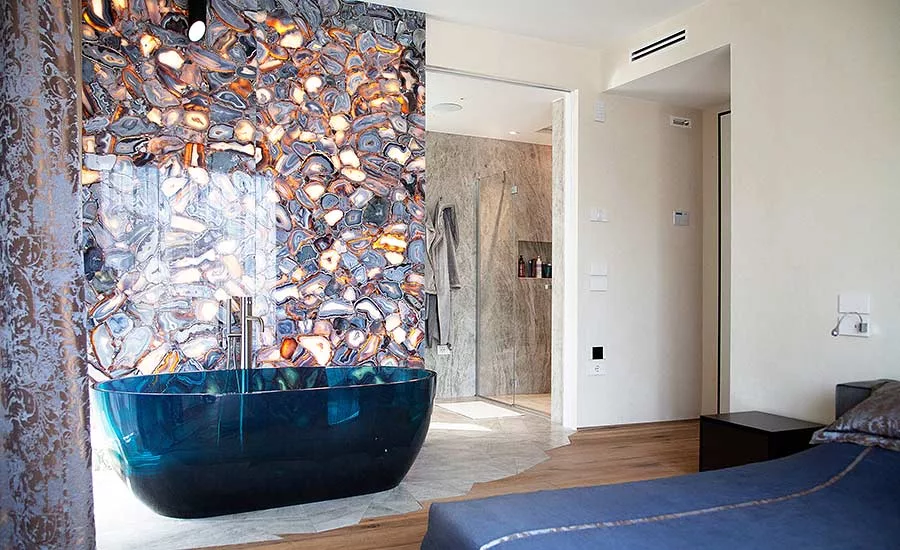 Antolini Treviso: Wild Agate Light forms a striking accent wall in a bedroom suite. 