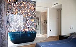 Antolini Treviso: Wild Agate Light forms a striking accent wall in a bedroom suite. 