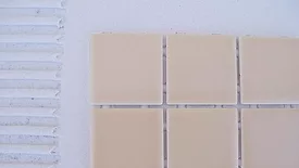 applying mortar to a mosaic tile installation