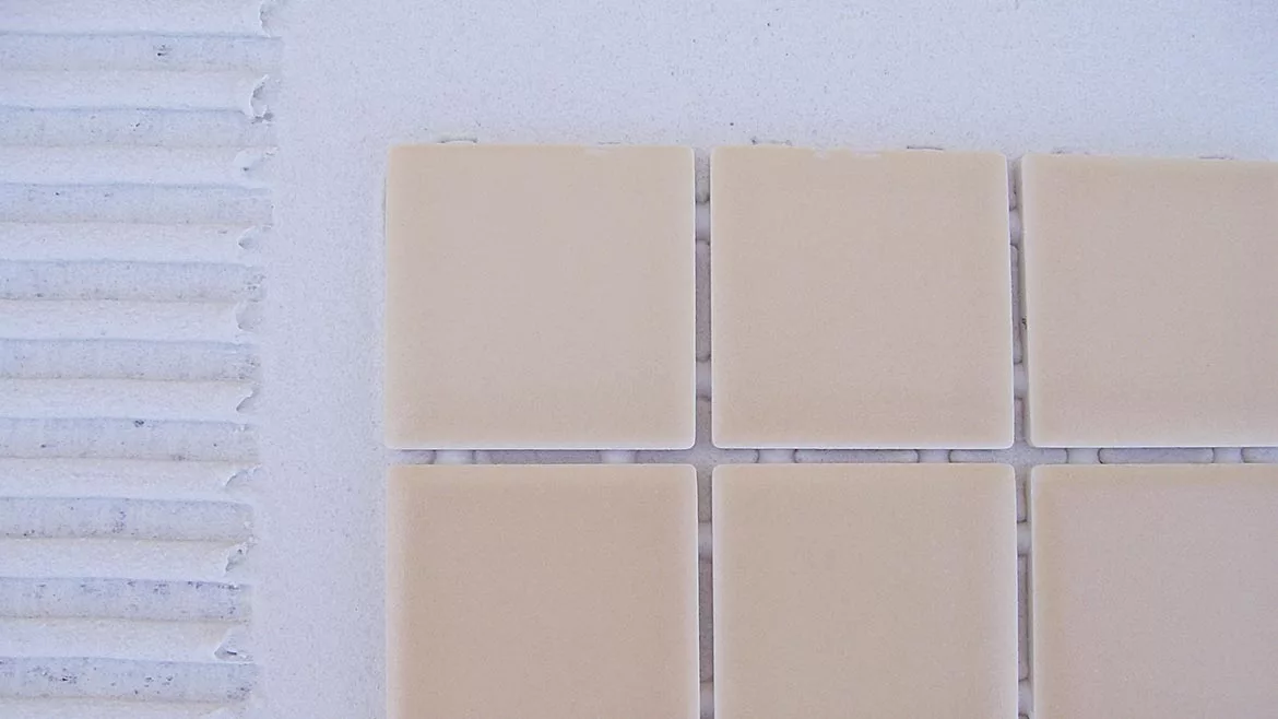 applying mortar to a mosaic tile installation
