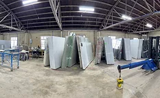  a warehouse storing large slabs of natural and engineered stone