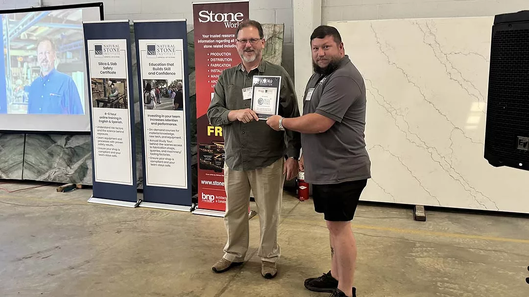 Jason Osborne receives a certificate of appreciation from speaker Ed Young