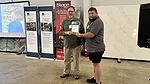 Jason Osborne receives a certificate of appreciation from speaker Ed Young
